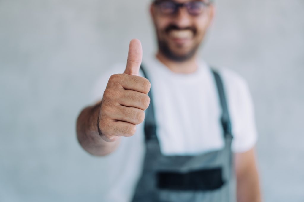 Young Male Worker In An Overall Uniform Posing At His Workplace